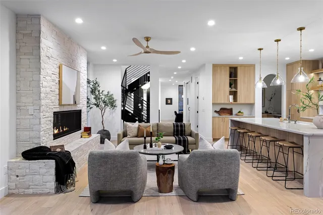 a living room with fireplace furniture and a chandelier