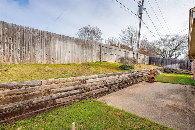a view of a house with wooden fence