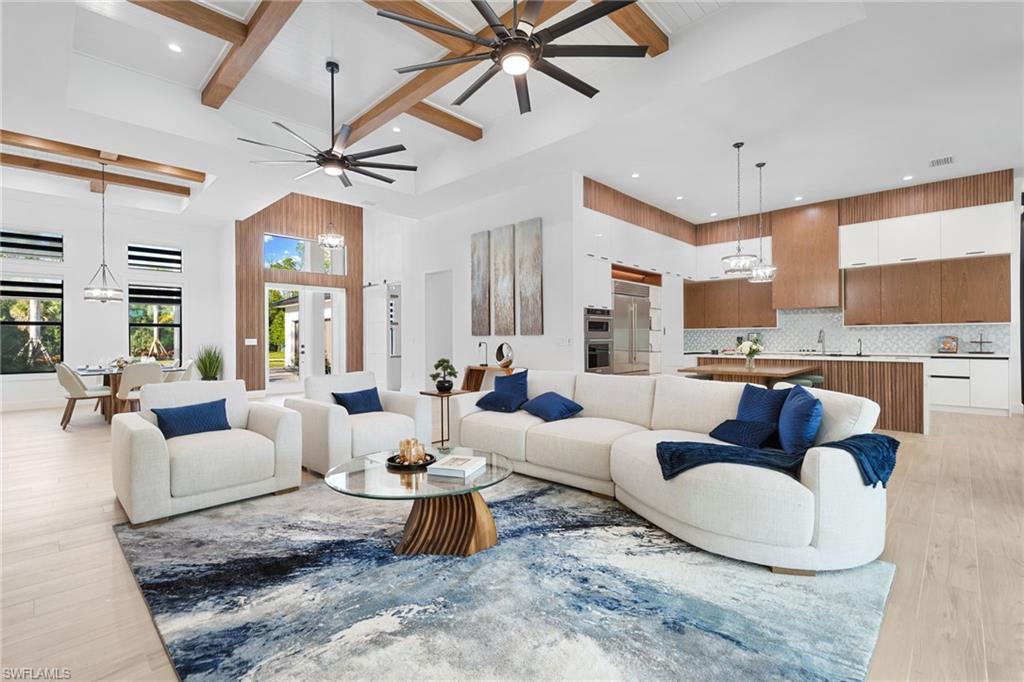 7040 Sable Ridge Lane Naples, FL 34109 - Photo 5 of 50 Thoughtfully curated—wood-look tile flooring and soaring ceilings with rich custom wood beams