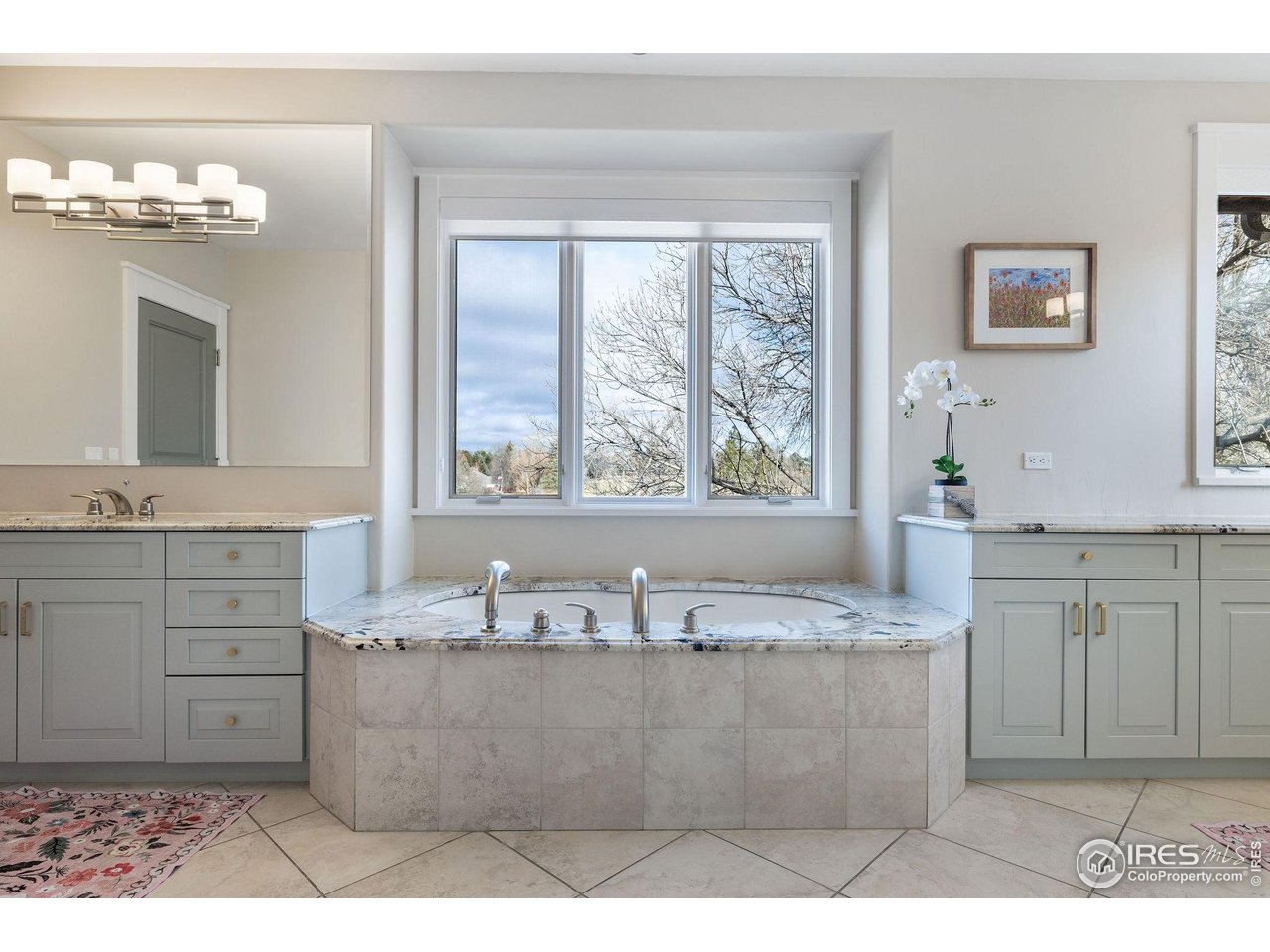 7205 Rustic Trail Boulder, CO 80301 - Photo 31 of 49 a bathroom with a granite countertop sink a large mirror and a bathtub