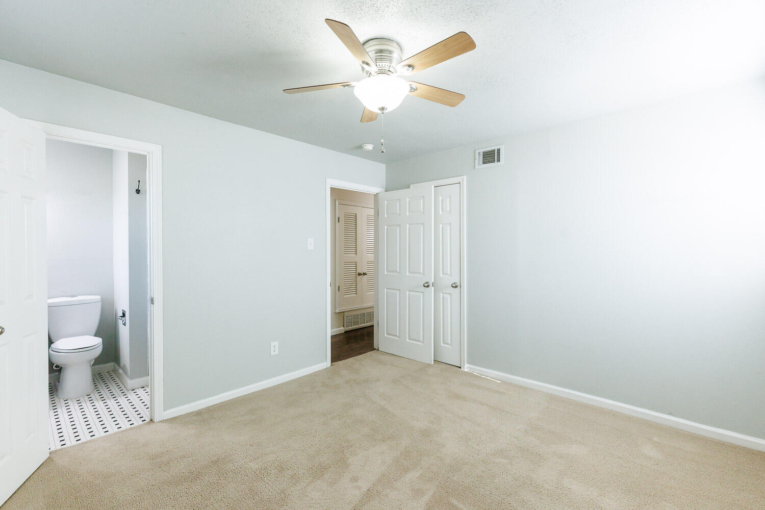4816 45th Street Lubbock, TX 79414 - Photo 19 of 36 a view of a room with a stylish ceiling fan and hardwood floor