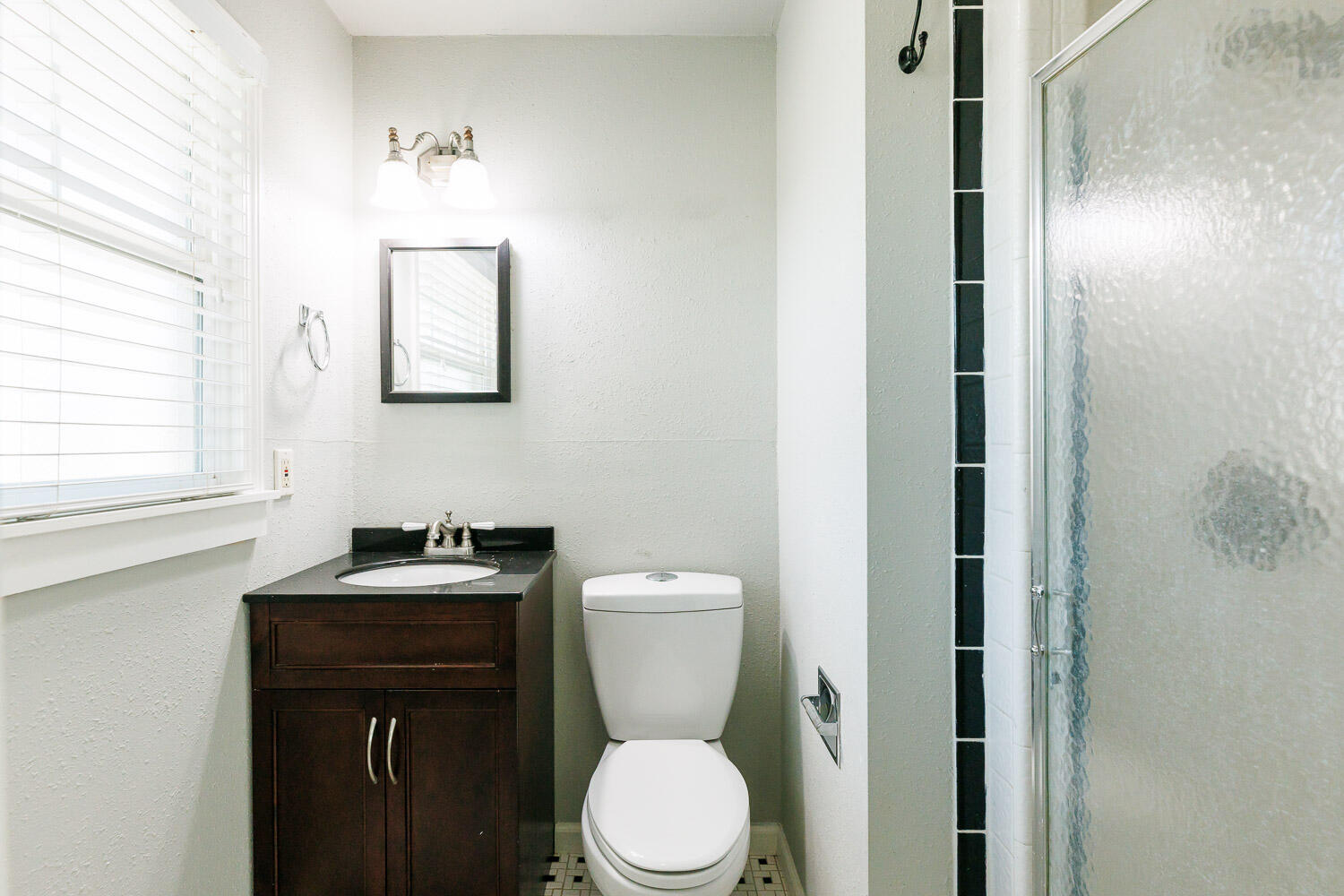 4816 45th Street Lubbock, TX 79414 - Photo 21 of 36 a bathroom with a toilet a sink a vanity and mirror