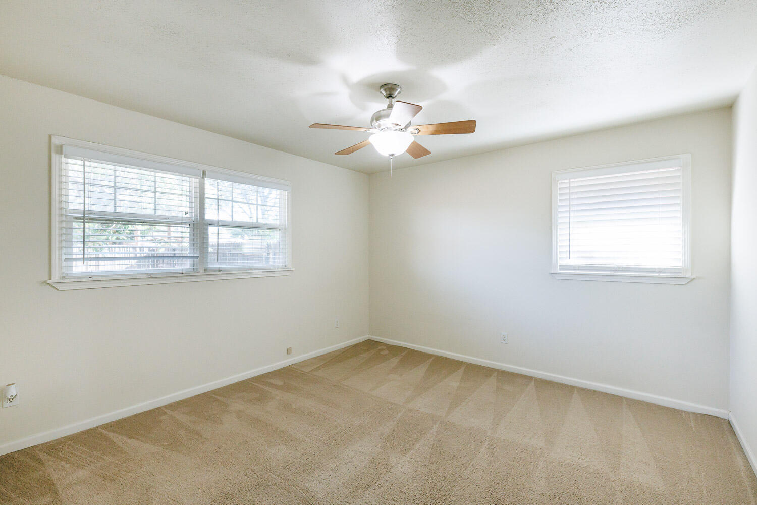 4816 45th Street Lubbock, TX 79414 - Photo 24 of 36 an empty room with windows and fan