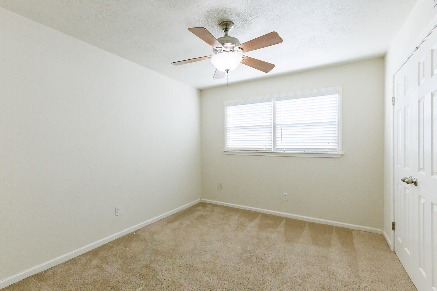 4816 45th Street Lubbock, TX 79414 - Photo 29 of 36 an empty room with a window and a fan