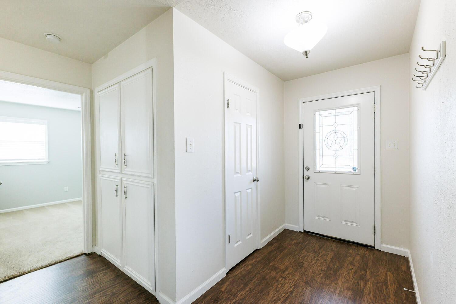 4816 45th Street Lubbock, TX 79414 - Photo 5 of 36 a view of an empty room with wooden floor and closet