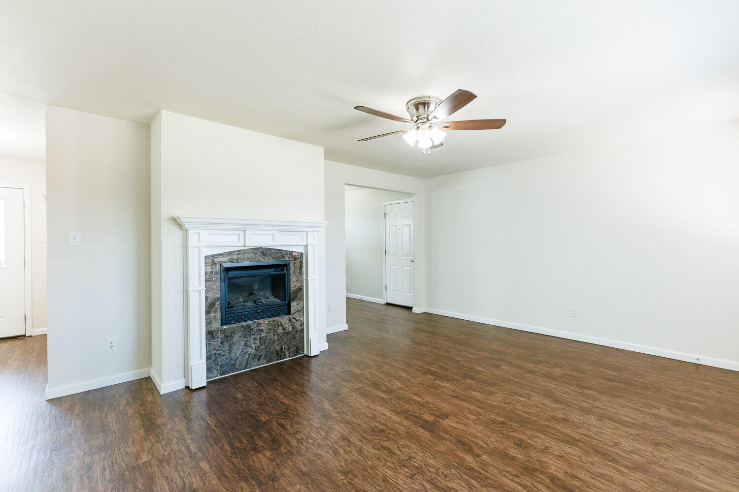 4816 45th Street Lubbock, TX 79414 - Photo 7 of 36 a view of an empty room with wooden floor and a fireplace