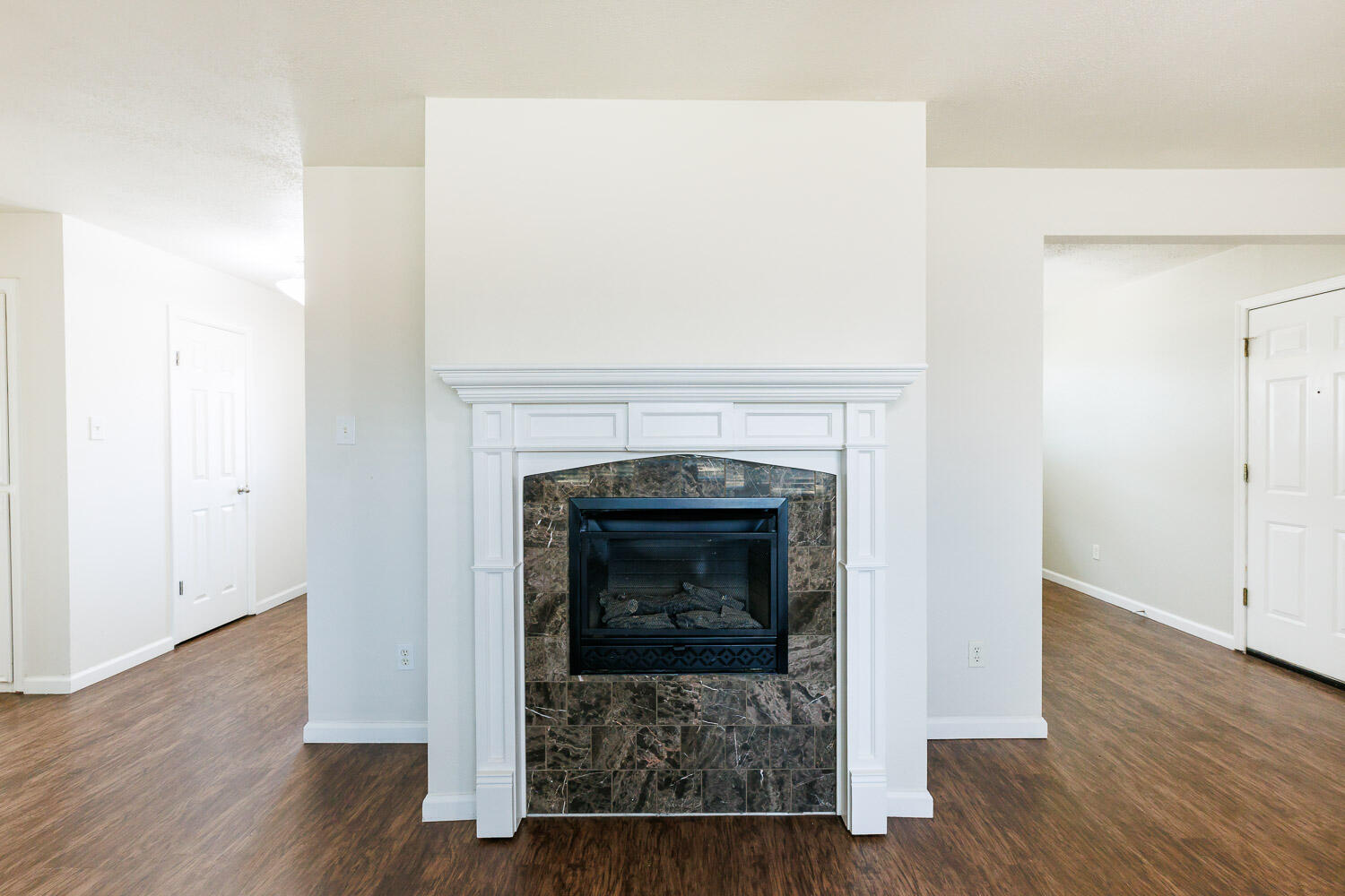 4816 45th Street Lubbock, TX 79414 - Photo 8 of 36 a living room with a fireplace and wooden floor