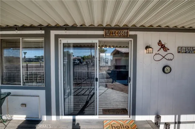 a view of a porch with wooden floor and furniture