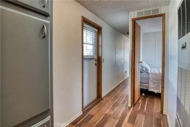 a view of a balcony with chairs and a yard