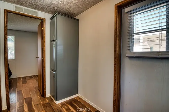 a view of a backyard with a garden and palm trees