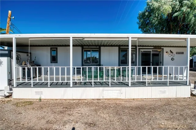 a view of a house with backyard and sitting area