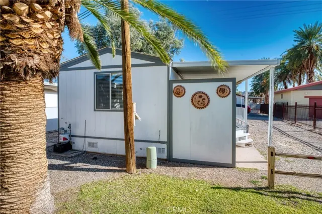 a kitchen with granite countertop a table chairs stove a sink dishwasher and cabinets with wooden floor