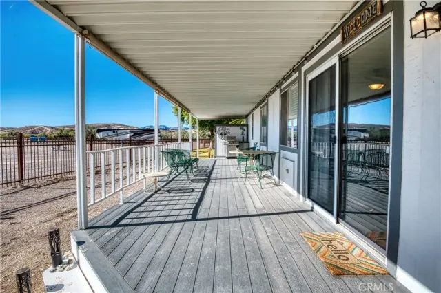 a view of a porch with wooden floor and furniture