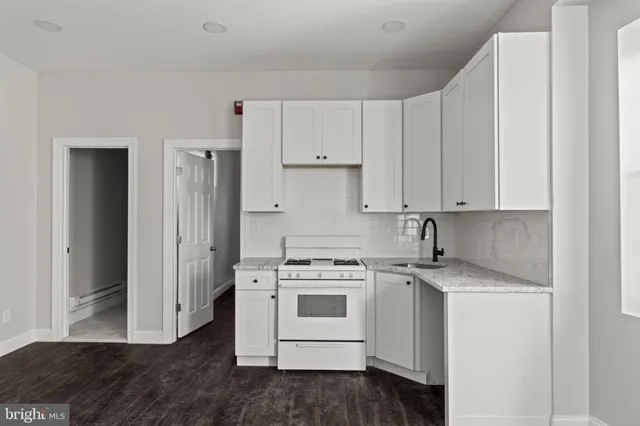 a kitchen with white cabinets and white appliances