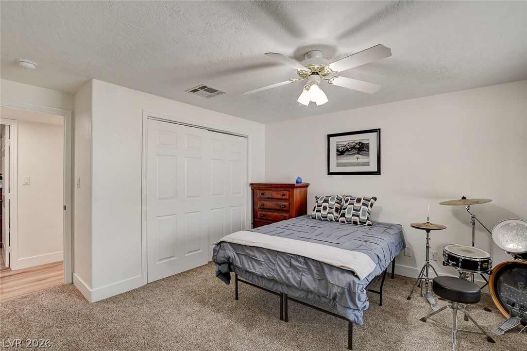 4362 Thistle Street Logandale, NV 89021 - Photo 61 of 99 A well-lit bedroom provides comfortable living with a dedicated closet and soft carpeting.