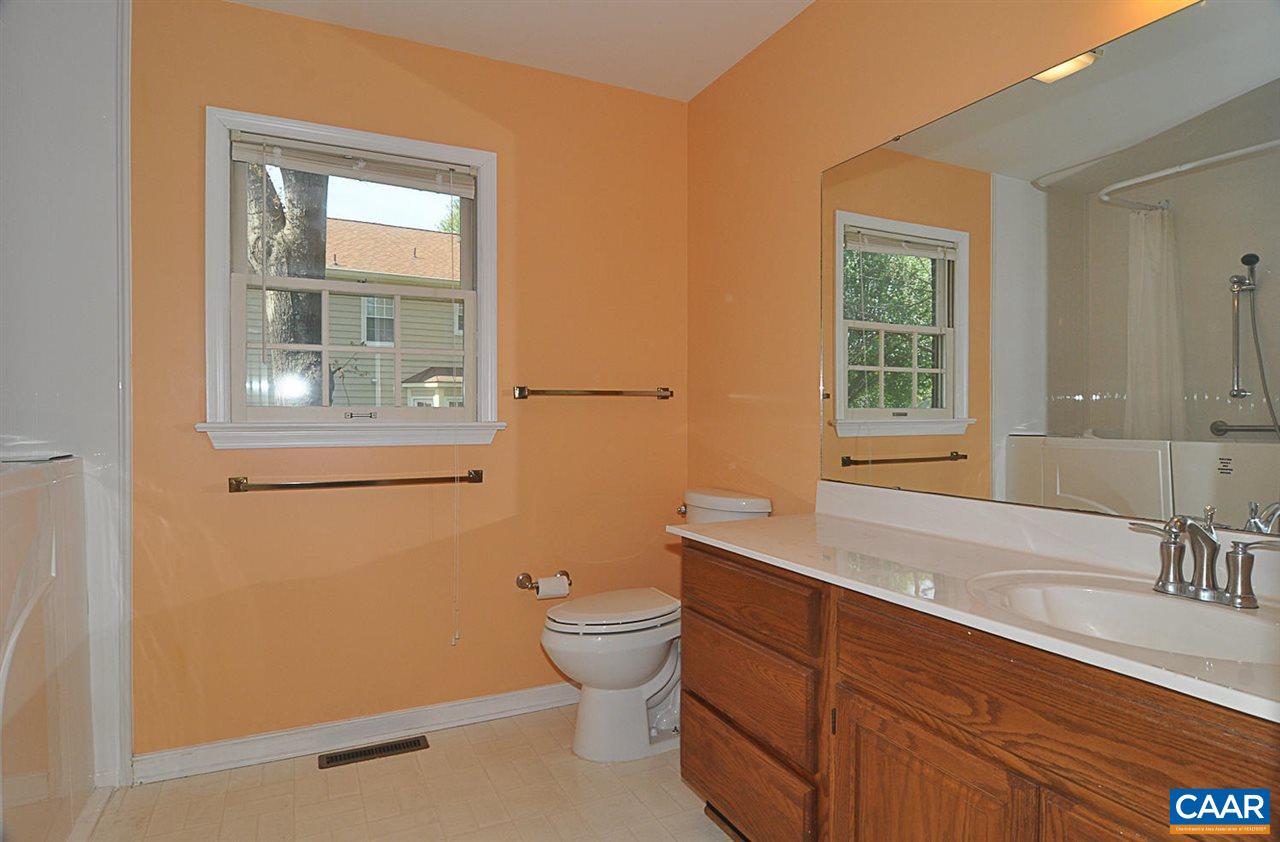 1576 Old Brook Road Charlottesville, VA 22901 - Photo 15 of 42 a bathroom with a granite countertop toilet a sink a mirror and a window