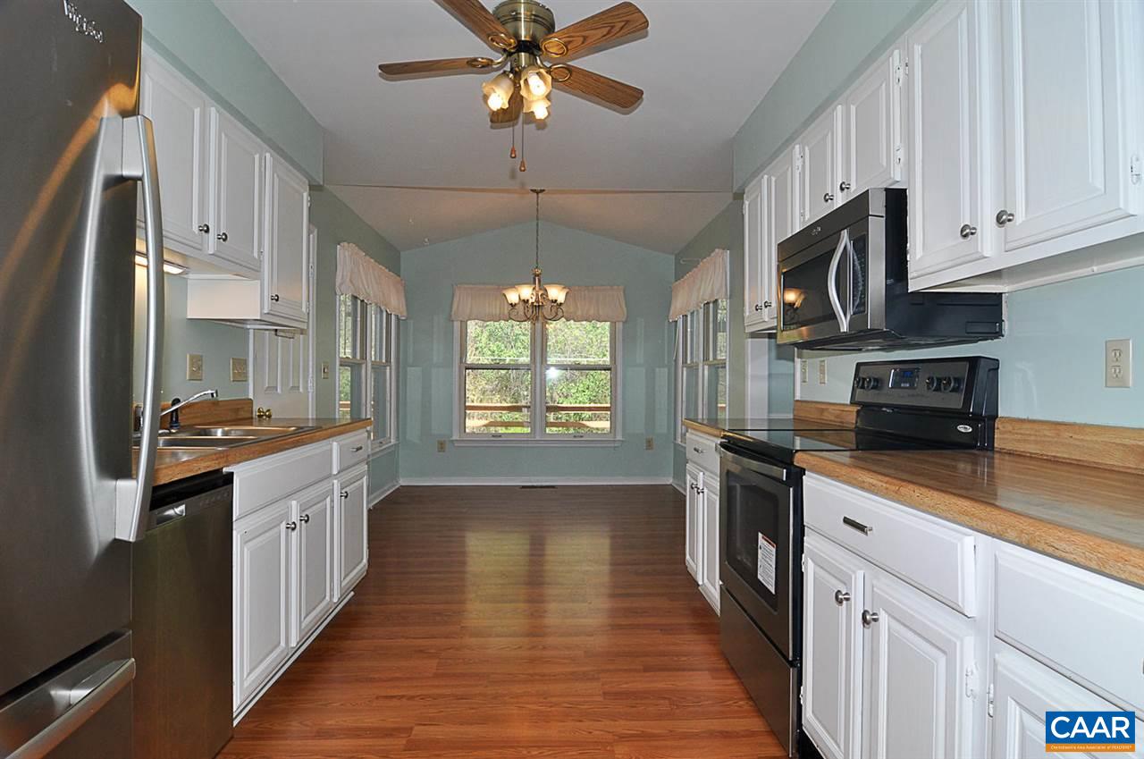 1576 Old Brook Road Charlottesville, VA 22901 - Photo 3 of 42 a kitchen with stainless steel appliances granite countertop a sink a stove top oven a refrigerator cabinets and wooden floor