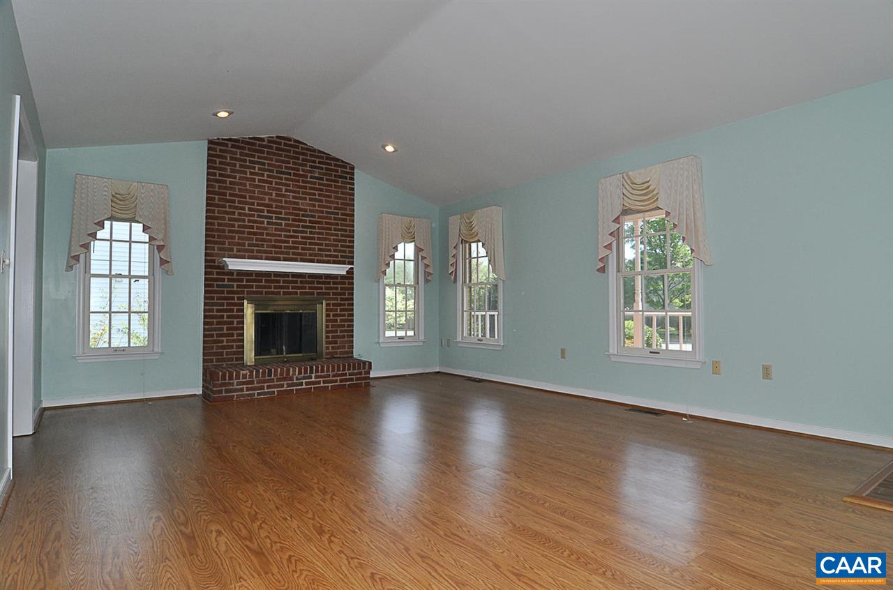 1576 Old Brook Road Charlottesville, VA 22901 - Photo 6 of 42 an empty room with wooden floor fireplace and windows