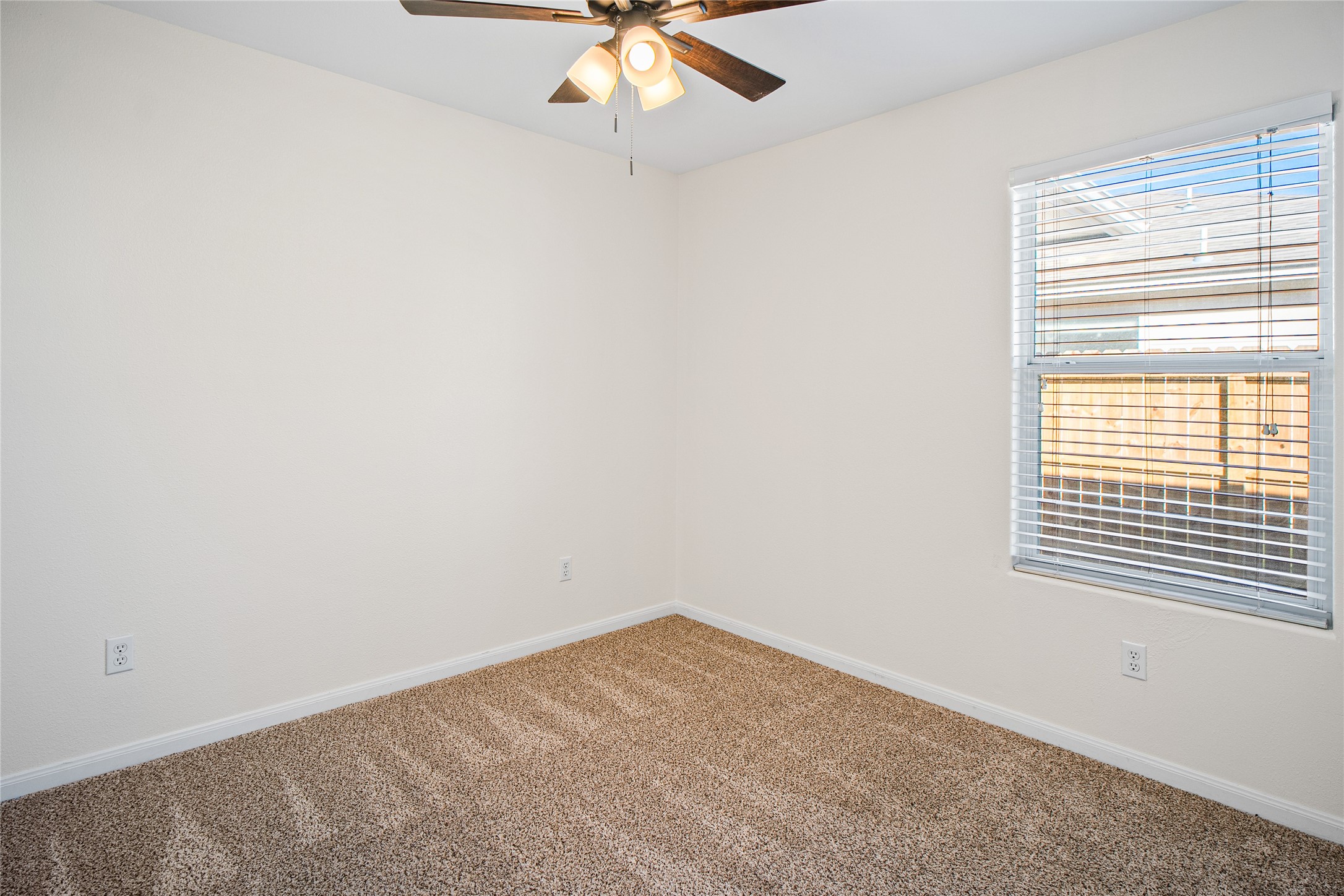 2224 Shady Tree Lane Conroe, TX 77301 - Photo 14 of 20 an empty room with a window and a fan