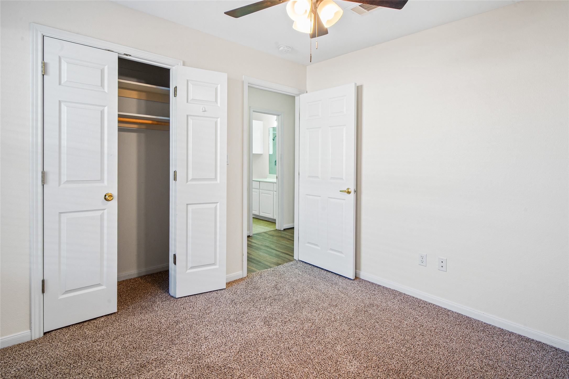 2224 Shady Tree Lane Conroe, TX 77301 - Photo 15 of 20 an empty room with closet and a chandelier fan