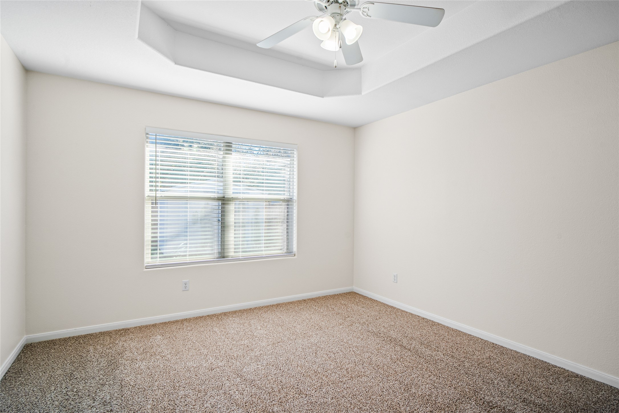 2224 Shady Tree Lane Conroe, TX 77301 - Photo 16 of 20 an empty room with a chandelier fan and window