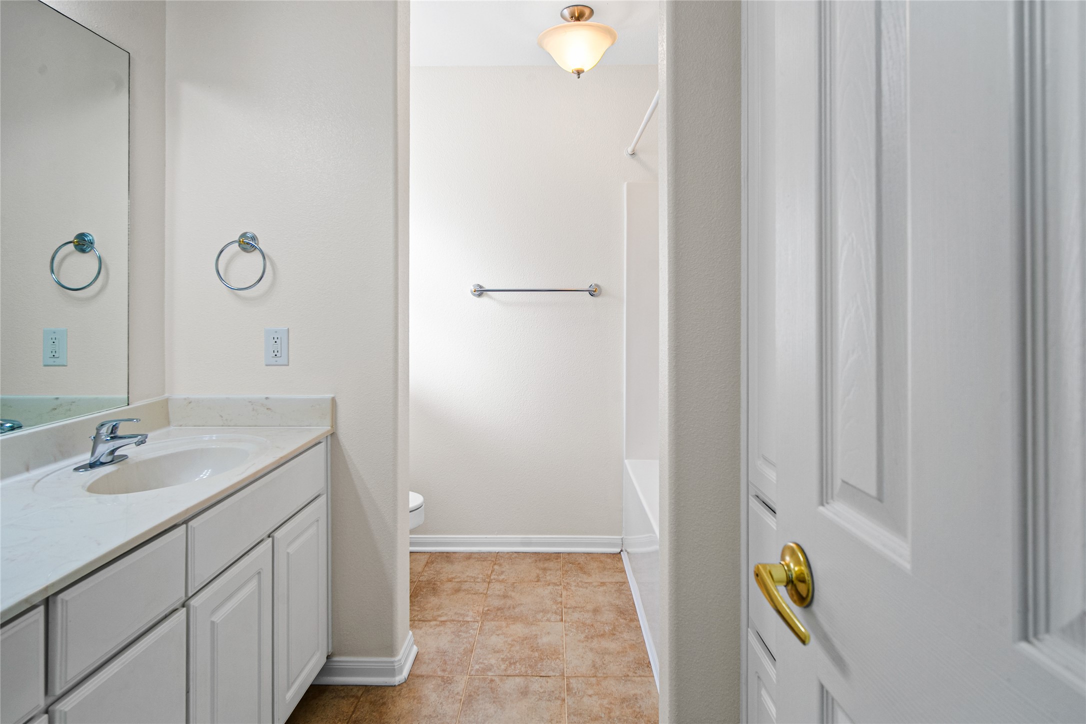 2224 Shady Tree Lane Conroe, TX 77301 - Photo 19 of 20 a bathroom with a granite countertop sink and a mirror
