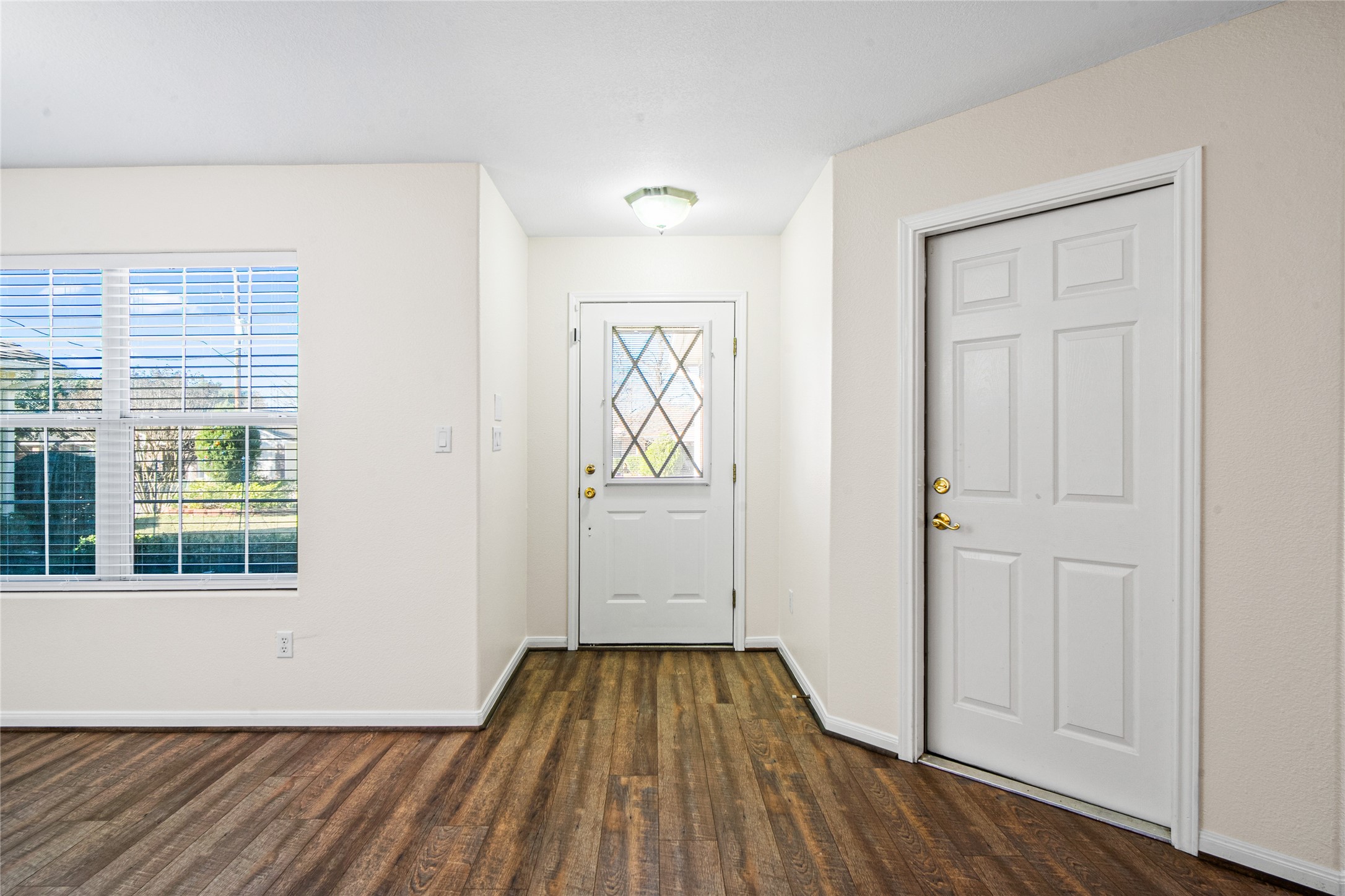 2224 Shady Tree Lane Conroe, TX 77301 - Photo 5 of 20 an empty room with wooden floor closet and windows