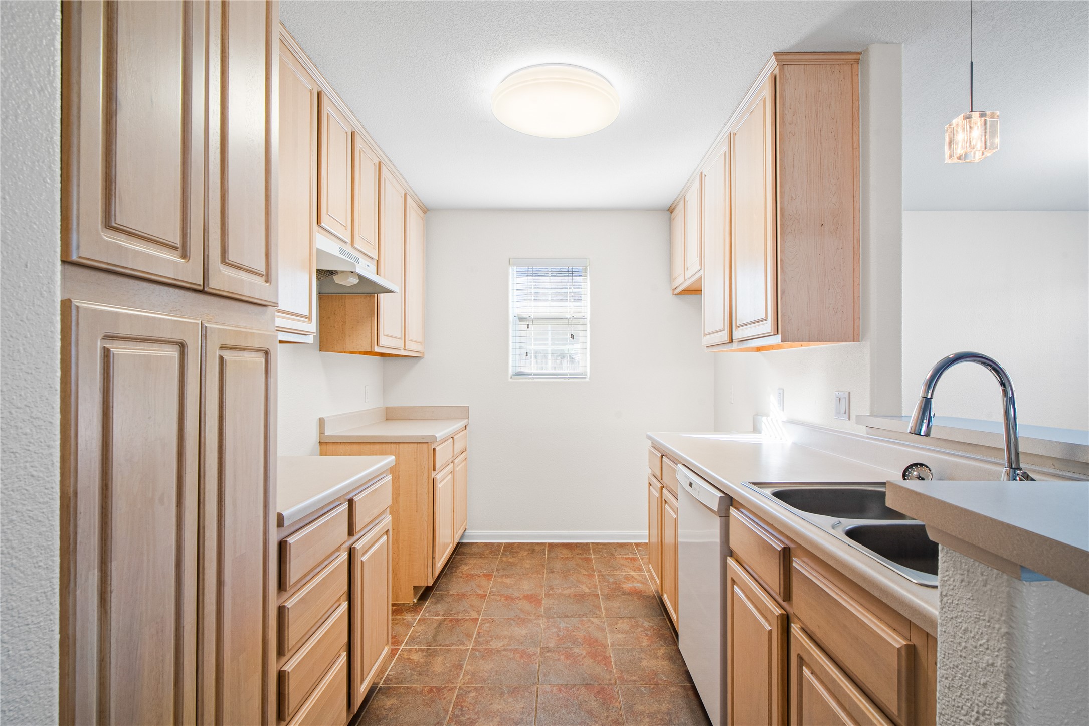 2224 Shady Tree Lane Conroe, TX 77301 - Photo 8 of 20 a kitchen with stainless steel appliances granite countertop a sink and dishwasher a refrigerator with wooden cabinets