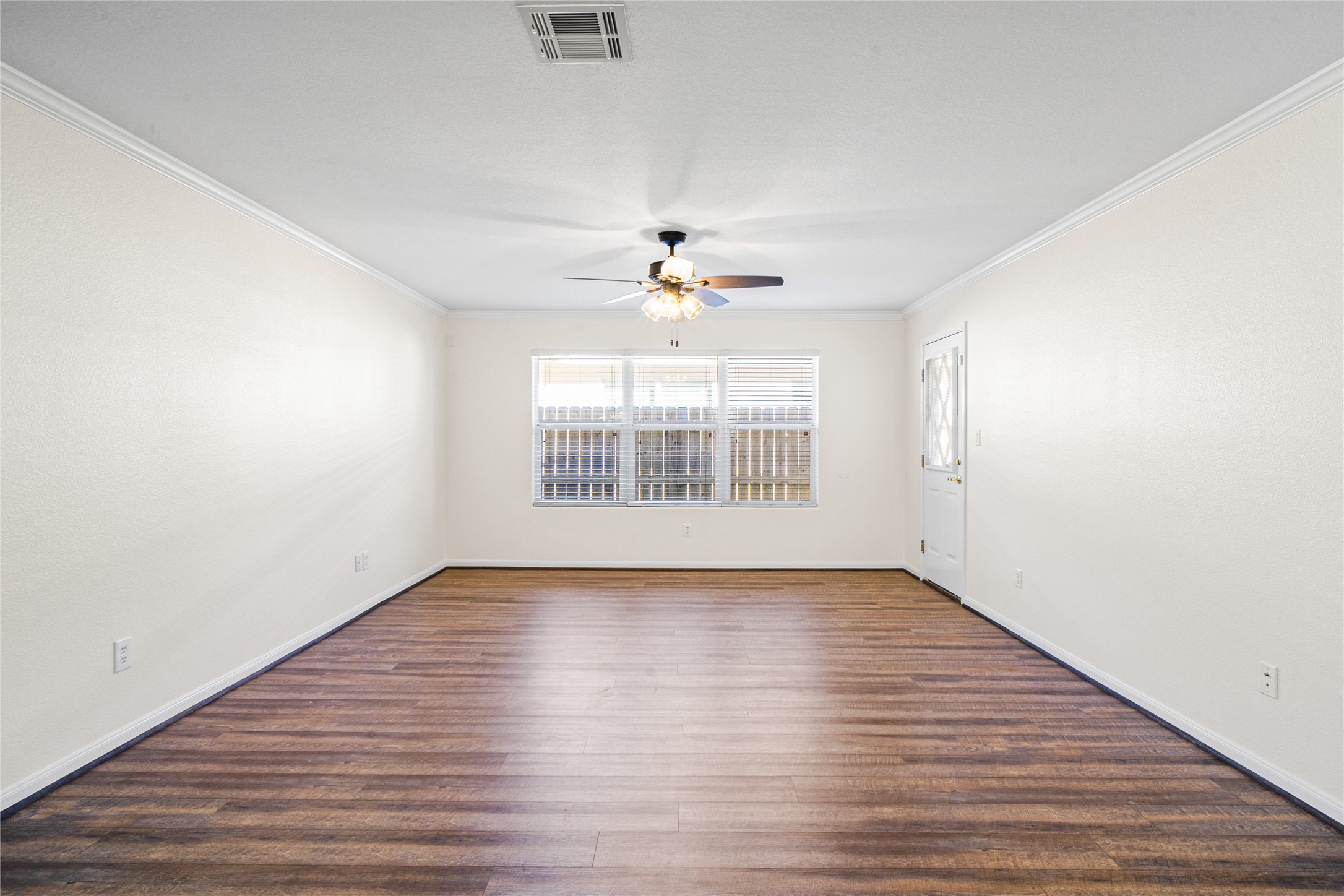 2224 Shady Tree Lane Conroe, TX 77301 - Photo 9 of 20 a view of an empty room with wooden floor and a window