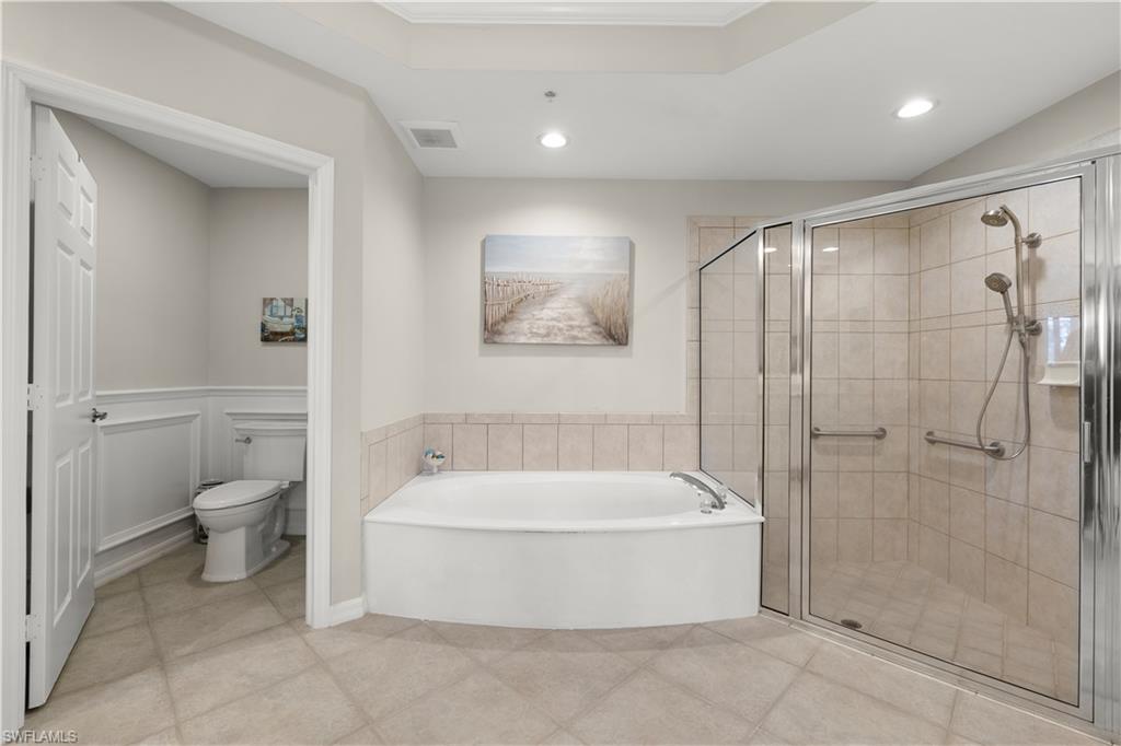 1635 Winding Oaks Way, Unit 101 Naples, FL 34109 - Photo 17 of 37 a bathroom with a tub and shower