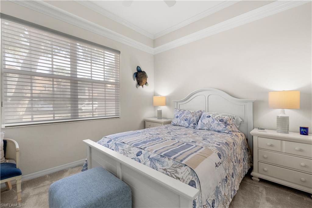 1635 Winding Oaks Way, Unit 101 Naples, FL 34109 - Photo 19 of 37 a bedroom with a bed and a window