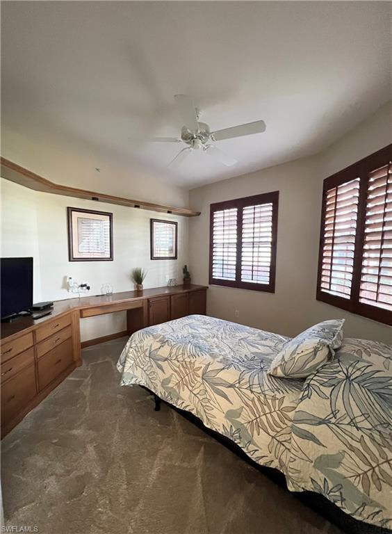 1635 Winding Oaks Way, Unit 101 Naples, FL 34109 - Photo 21 of 37 a bedroom with a large bed and a flat screen tv