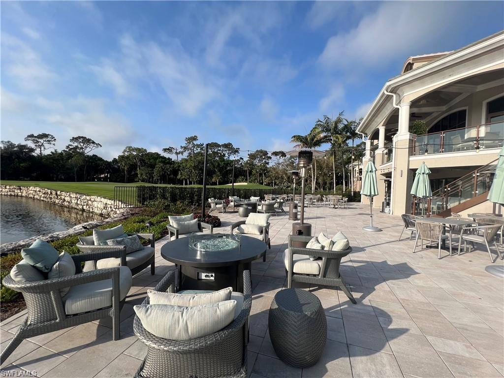 1635 Winding Oaks Way, Unit 101 Naples, FL 34109 - Photo 28 of 37 a terrace with outdoor seating and city view