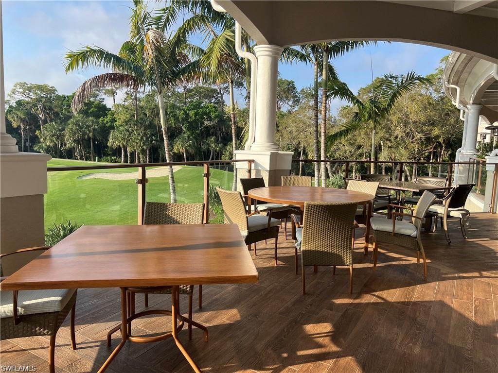 1635 Winding Oaks Way, Unit 101 Naples, FL 34109 - Photo 29 of 37 a view of outdoor dining space with a table and chairs