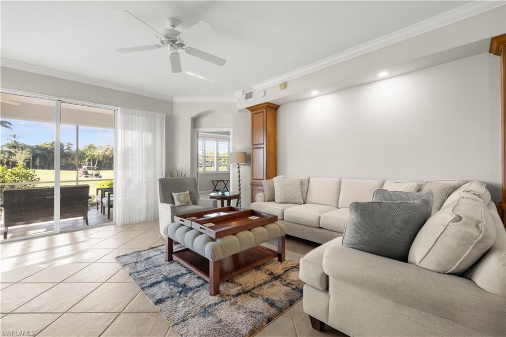 1635 Winding Oaks Way, Unit 101 Naples, FL 34109 - Photo 3 of 37 a living room with furniture and a chandelier