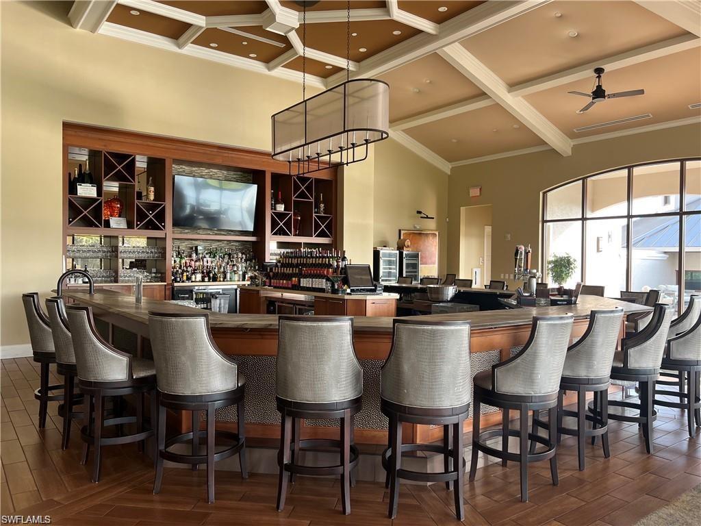 1635 Winding Oaks Way, Unit 101 Naples, FL 34109 - Photo 32 of 37 a dining hall with stainless steel appliances granite countertop a stove a sink a dining table and chairs