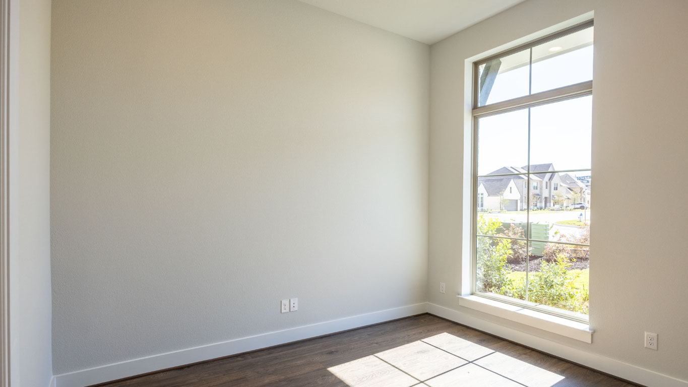 255 Star Rush Trail Georgetown, TX 78633 - Photo 11 of 16 Unfurnished room featuring baseboards and dark wood-type flooring