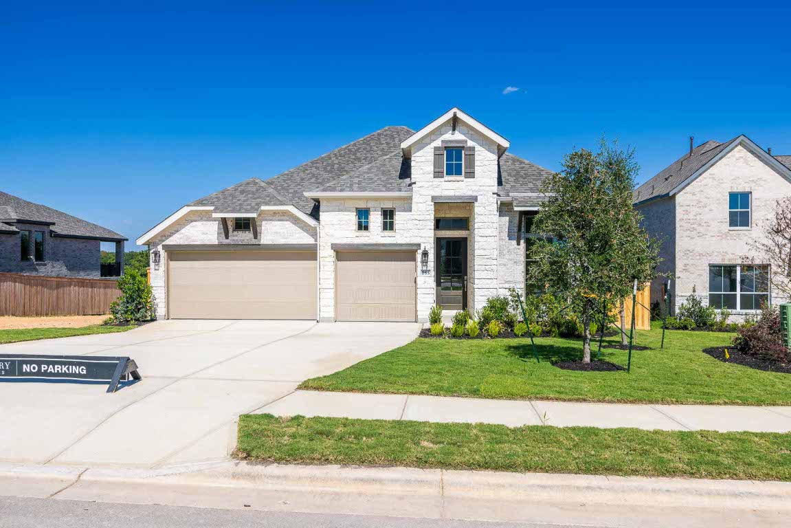 255 Star Rush Trail Georgetown, TX 78633 - Photo 2 of 16 View of front facade with stone siding, driveway, a shingled roof, a garage, and brick siding