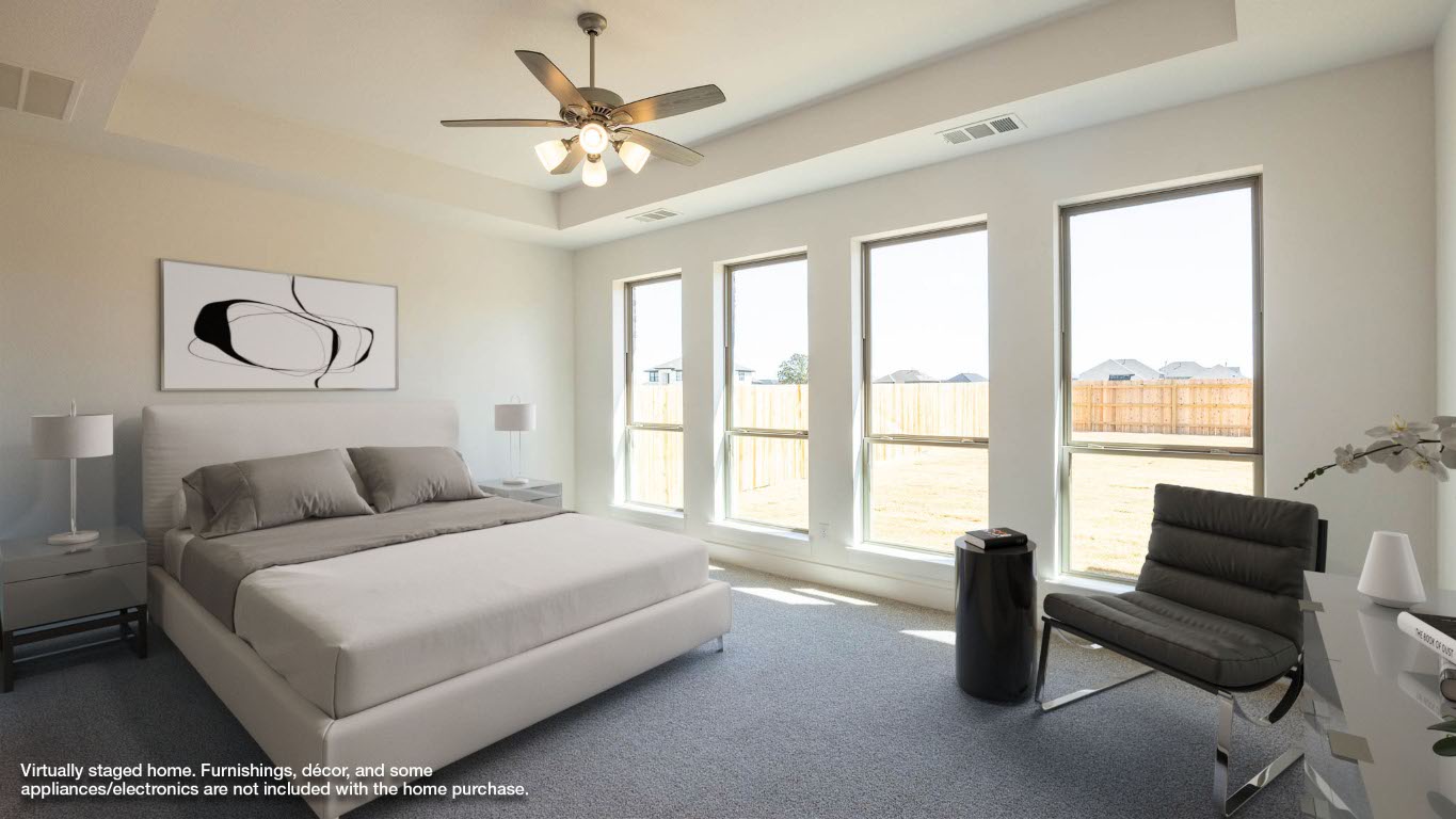255 Star Rush Trail Georgetown, TX 78633 - Photo 5 of 16 Bedroom featuring a tray ceiling, carpet floors, and a ceiling fan