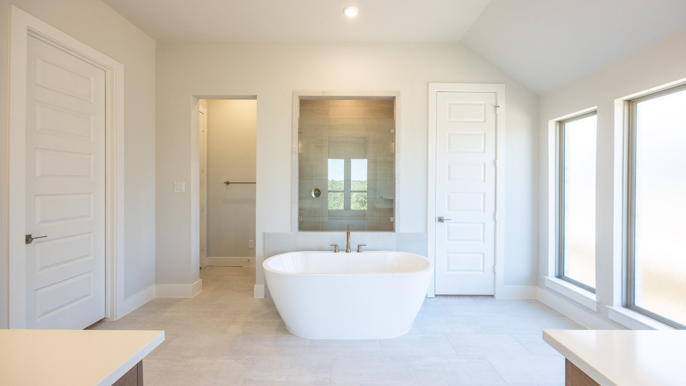 255 Star Rush Trail Georgetown, TX 78633 - Photo 10 of 16 Full bathroom with a freestanding tub, a tile shower, light tile patterned flooring, and recessed lighting