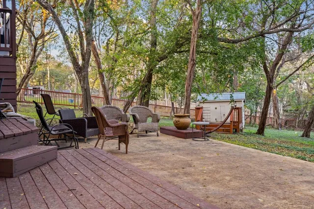 a view of a patio with table and chairs and wooden floor