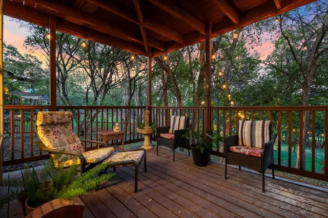 a view of a deck with wooden floor and outdoor seating