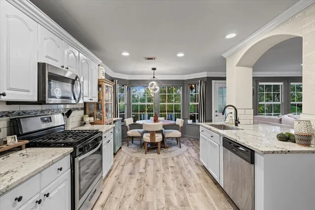 a kitchen with sink stove and refrigerator