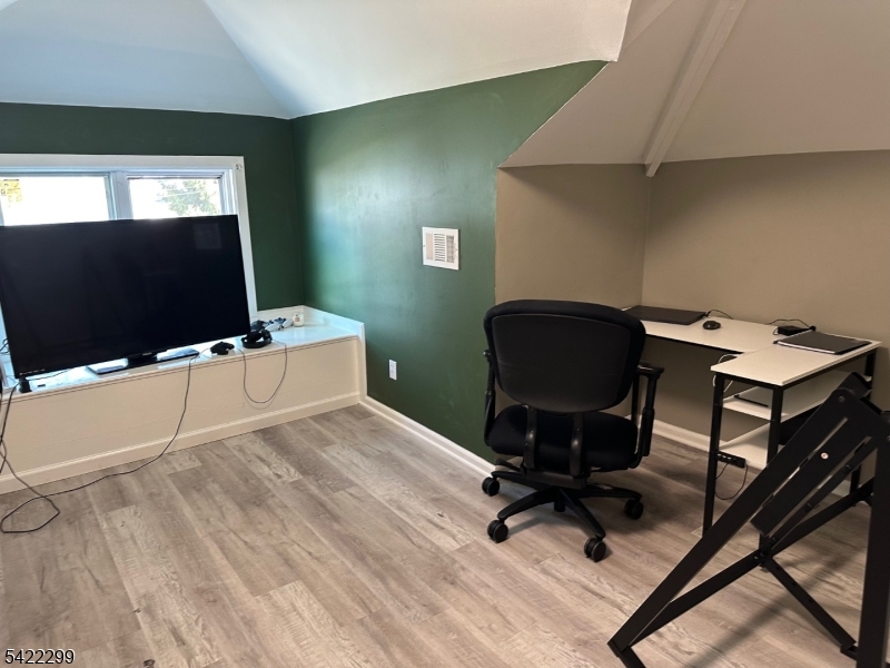 113 Pequannock Street Dover, NJ 07801 - Photo 13 of 17 a workspace with furniture and a flat screen tv