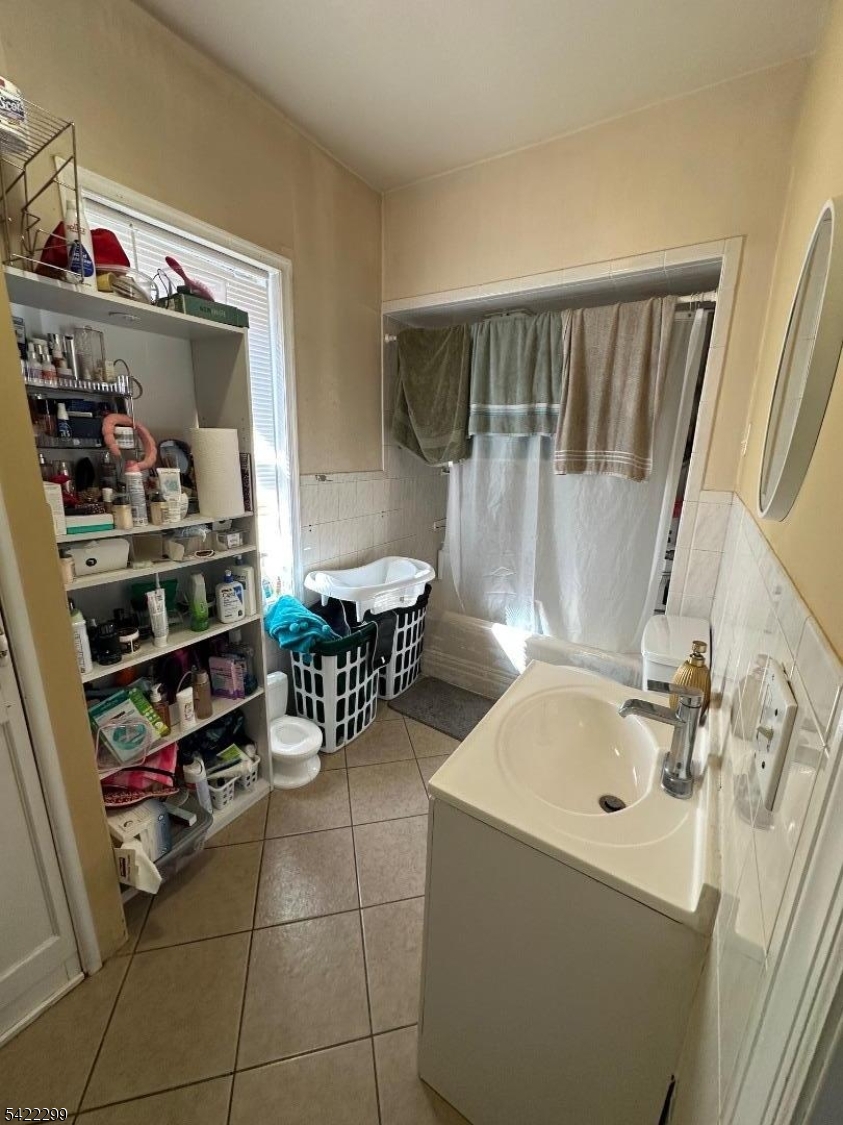 113 Pequannock Street Dover, NJ 07801 - Photo 14 of 17 a storage room with wooden shelves