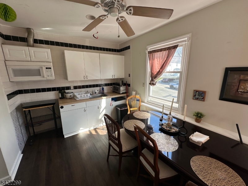 113 Pequannock Street Dover, NJ 07801 - Photo 4 of 17 a kitchen with a table chairs and a stove