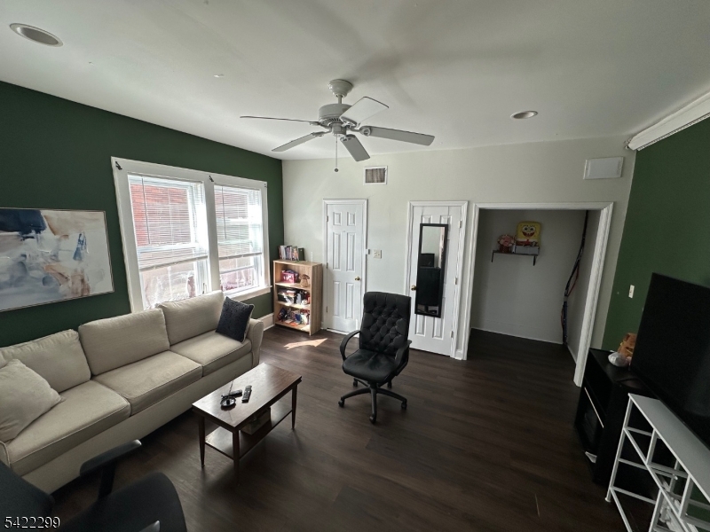 113 Pequannock Street Dover, NJ 07801 - Photo 6 of 17 a living room with furniture a flat screen tv and a window