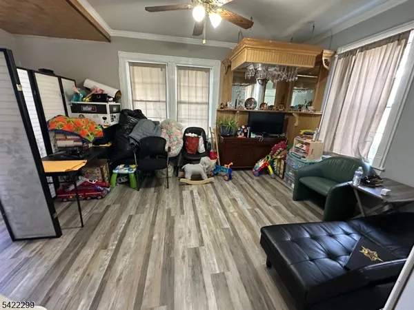 a living room filled with furniture and a wooden floor