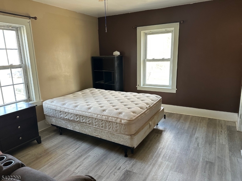 113 Pequannock Street Dover, NJ 07801 - Photo 10 of 17 a bedroom with a bed and wooden floor