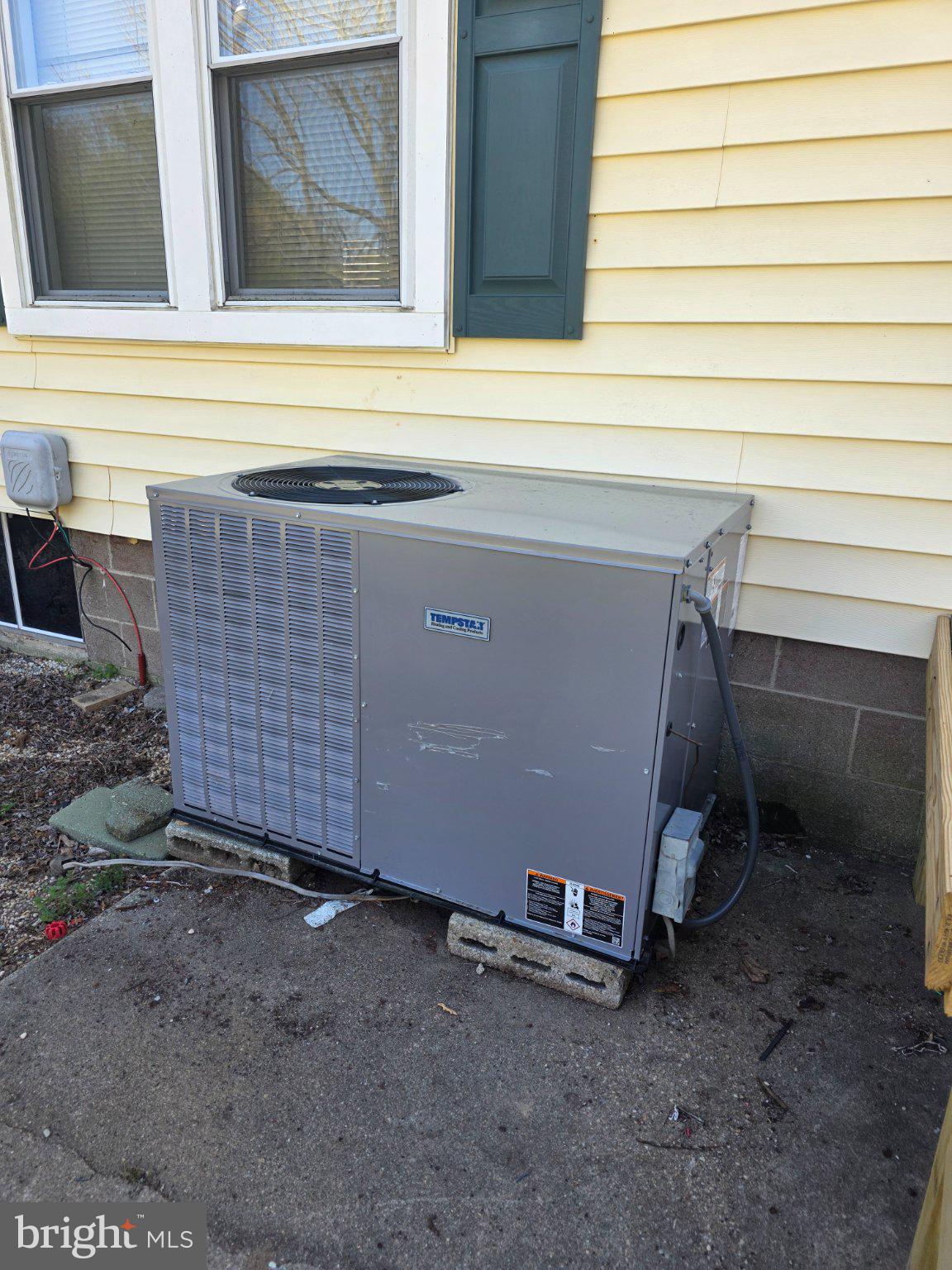 150 West Street Magnolia, DE 19962 - Photo 17 of 26 Cooling unit by a sunny facade.